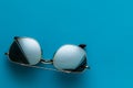 Sunglasses. Silver - colored meta l, on a blue background