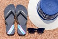 Sunglasses, Slip slops and sunhat on a tropical beach Royalty Free Stock Photo