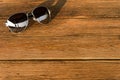 The sunglasses sliver frame is on the wood table Royalty Free Stock Photo