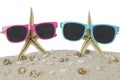 Sunglasses and starfish on beach sand Royalty Free Stock Photo