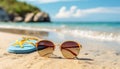 Sunglasses and sunhat on a sandy beach with tropical sea background Royalty Free Stock Photo