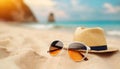 Sunglasses and sunhat on a sandy beach with tropical sea background Royalty Free Stock Photo