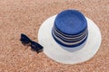 Sunglasses and sunhat on a tropical beach Royalty Free Stock Photo