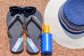 Sunglasses, suntan lotion, Slip slops and sunhat on a tropical beach Royalty Free Stock Photo