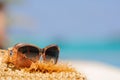 Sunglasses in tropic ocean background