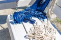 Sunglasses on a white bench with a magazine, rope, hat and bag. Beach holidays, travel, resort Royalty Free Stock Photo