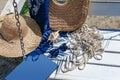 Sunglasses on a white bench with a magazine, rope, hat and bag. Beach holidays, travel, resort Royalty Free Stock Photo