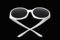 Sunglasses in a white plastic frame, isolate on a black background Royalty Free Stock Photo