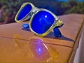 Sunglasses on a yellow wall Royalty Free Stock Photo