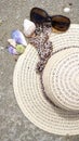 Sunhat, sunglasses and shells on the beach, closeup, 