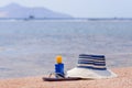 Sunhat, thongs and sunscreen on a beach Royalty Free Stock Photo