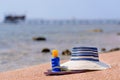 Sunhat, thongs and sunscreen on a beach Royalty Free Stock Photo