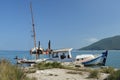 Sunk wooden boat and old rusty dredger