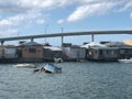 Sunken boats in water behind poor run down houses