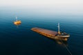 Sunken cargo ship near Crimean seaside, aerial view from drone. Shipwreck vessel with nose of ship above sea water