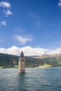 Sunken church tower in lake in the alps Royalty Free Stock Photo
