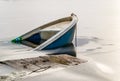 Sunken fishing boat in frozen lake water