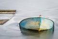 Sunken fishing boat in frozen lake water