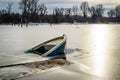 Sunken fishing boat in frozen lake water