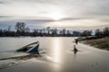 Sunken fishing boat in frozen lake water