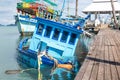 Sunken fishing boat near the pier Royalty Free Stock Photo