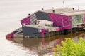 Sunken house in a river. Due to the flood, the building went under water at half the height of the wall