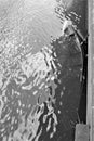 Sunken rowboat tied to pier submerged in water Royalty Free Stock Photo