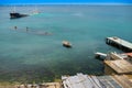 Sunken ship near old abandoned docks on the shore Royalty Free Stock Photo