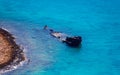 Sunken ship in the shallow blue water Royalty Free Stock Photo