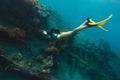 A sunken shipwreck in the mediterranean sea with a scuba diver
