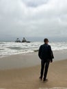 Sunken trawler, shipwreck. Ship Zeila at Skeleton Coast Namibia. Man stands. Royalty Free Stock Photo