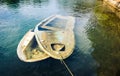 Sunken wooden boat in sea or lake tied to shore. Royalty Free Stock Photo