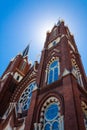 Sunlight backlight on an ornate Gothic Revival church exterior