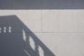 Sunlight and balcony shadow on surface of gray gypsum wall