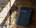 Sunlight on a Bible and wooden cross