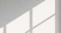 Sunlight Casting Geometric Shadows on a White Wall Surface abstract architectural Royalty Free Stock Photo