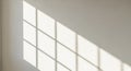 Sunlight Casting Grid Shadow Pattern on a White Wall window Royalty Free Stock Photo