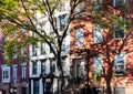 Sunlight casting shadows on the colorful old buildings on 10th Street in New York City