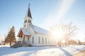 sunlight casting shadows on a snow-cloaked country church
