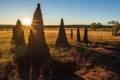 sunlight casting shadows on termite mounds