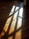 Sunlight Casting Unique Patterns on Polished Wood Floor in Quiet Indoor Space During Afternoon Hours Royalty Free Stock Photo