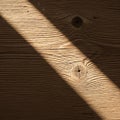 Sunlight casts an angular shadow across a textured wooden surface Royalty Free Stock Photo