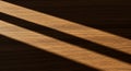 Sunlight casts diagonal shadows on a wooden surface, creating a pattern of Royalty Free Stock Photo