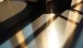 Sunlight casts geometric patterns on a smooth, reflective surface generated