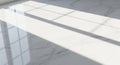 Sunlight casts long, rectangular shadows of window panes on a pristine, white marble Royalty Free Stock Photo