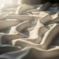 Sunlight casts over a crumpled beige fabric, creating an interplay of light and shadow Royalty Free Stock Photo