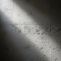 Sunlight casts shadows on a textured concrete wall, highlighting its rough and uneve Royalty Free Stock Photo