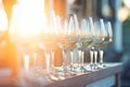 sunlight catching the hue of a full row of wine glasses at golden hour Royalty Free Stock Photo