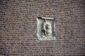 Sunlight falling on a stone carving embedded in a wall