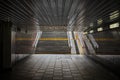 Sunlight falls on the stairs exit of a street underpass